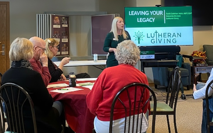 A group of people sitting around a table having a meeting.
